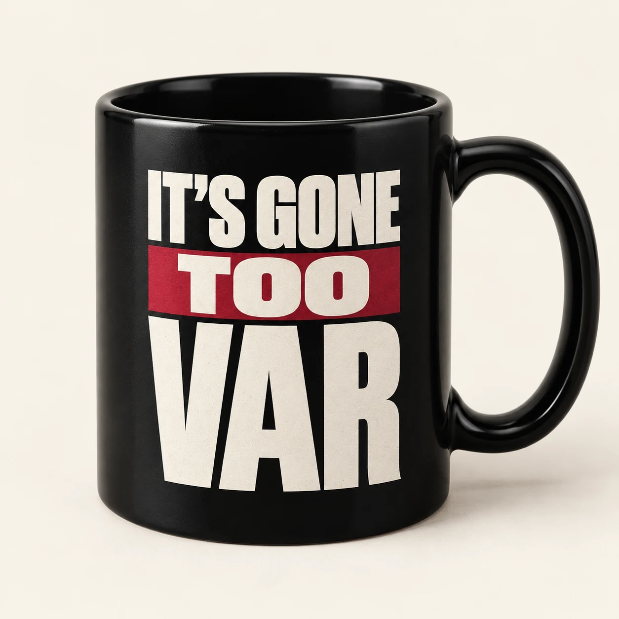 Design mockup of a black ceramic mug with the It’s Gone Too VAR logo in bone and oxblood